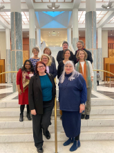 The delegation on the steps inside the Parliament House foyer